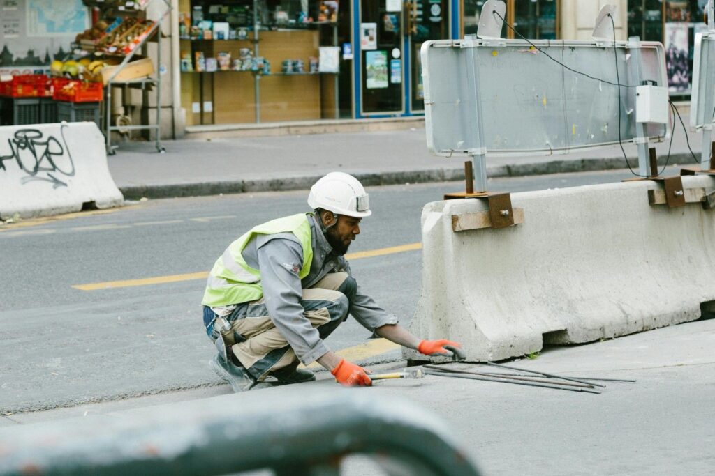 a man wearing a helmet and gloves working on a road