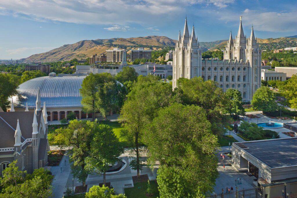 A Large White Building With Pointed Towers And Trees