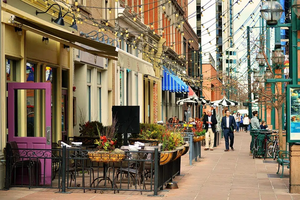 A Sidewalk With Tables And Chairs On It