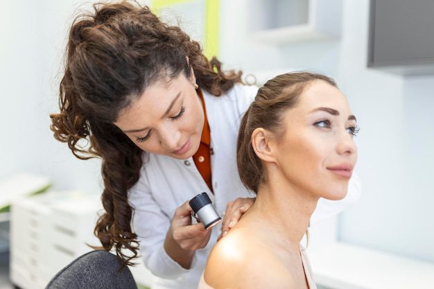 Dermatologist Latex Gloves Holding Dermatoscope While Examining Attractive Patient With Skin Disease Female Dermatologist Examining Patient With Dermascope Looking Signs Skin Cancer 657921 299 1