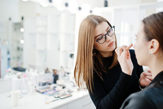 a woman putting on makeup