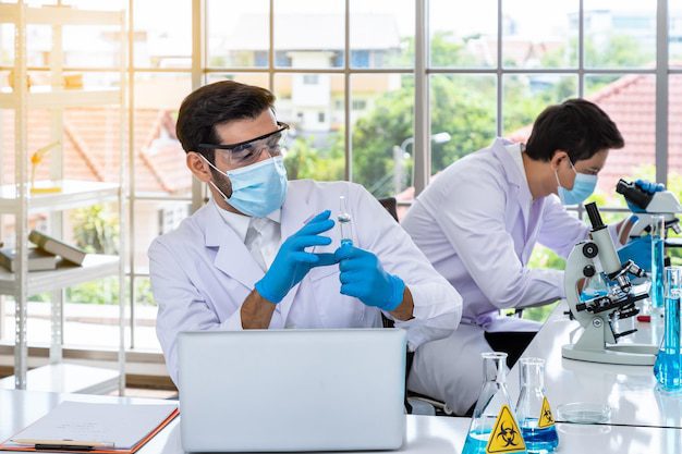 Two Male Asian Arab Researcher Scientists Working Laboratory Conducting Study Biohazard Substance With Scientific Equipment Microscope 554837 761