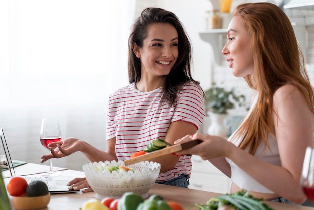 a couple of women in a kitchen